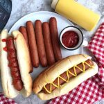 a white plate of instant pot hot dogs